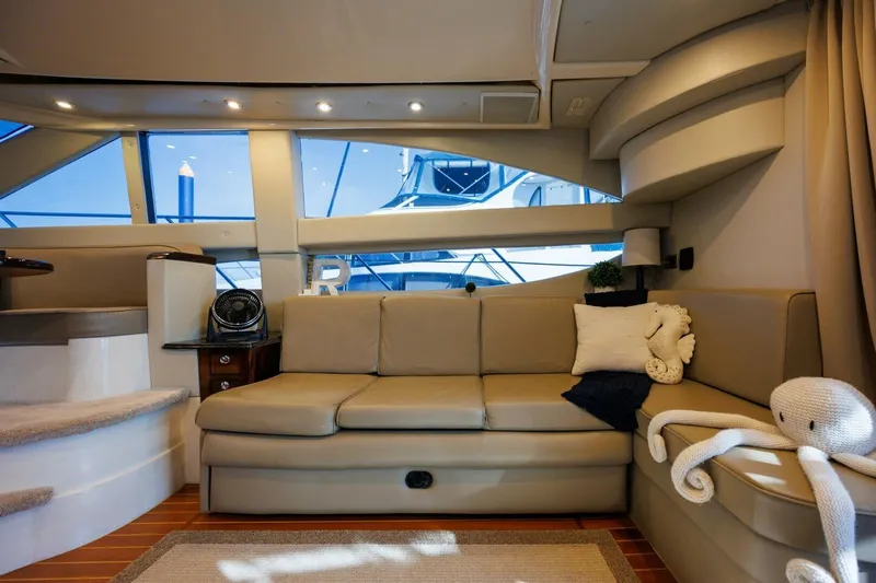 Why Knot Yacht Photos Pics Luxurious interior of 2010 Meridian 391 Sedan yacht with plush seating and nautical decor.