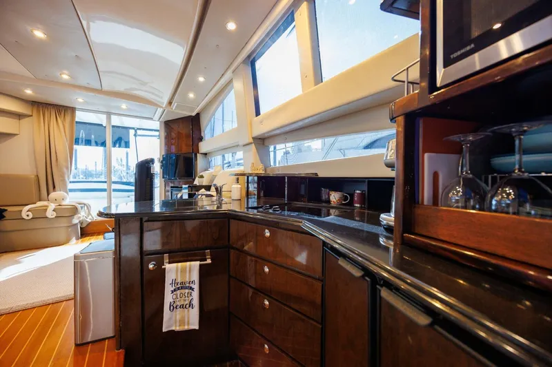 Why Knot Yacht Photos Pics Luxurious interior of 2010 Meridian 391 Sedan yacht with modern kitchen amenities.