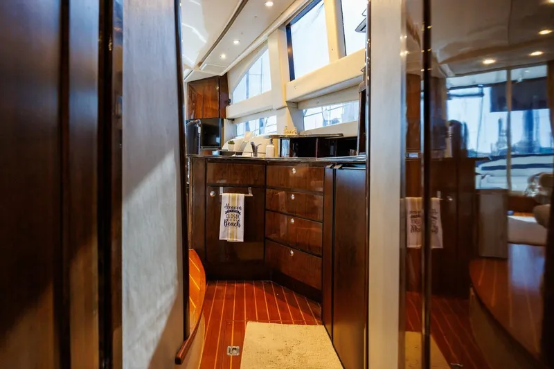 Why Knot Yacht Photos Pics Interior of 2010 Meridian 391 Sedan yacht with modern kitchen and wood finish.