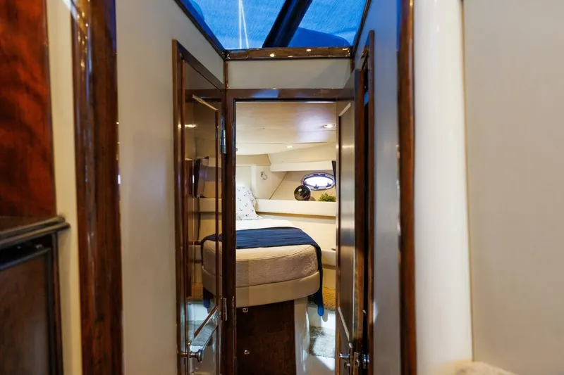 Why Knot Yacht Photos Pics Luxurious interior of 2010 Meridian 391 Sedan yacht bedroom with elegant wood finishes.