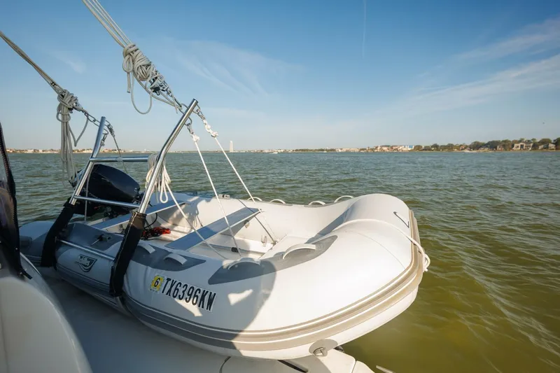 Why Knot Yacht Photos Pics Inflatable boat on water, attached to 2010 Meridian 391 Sedan yacht.