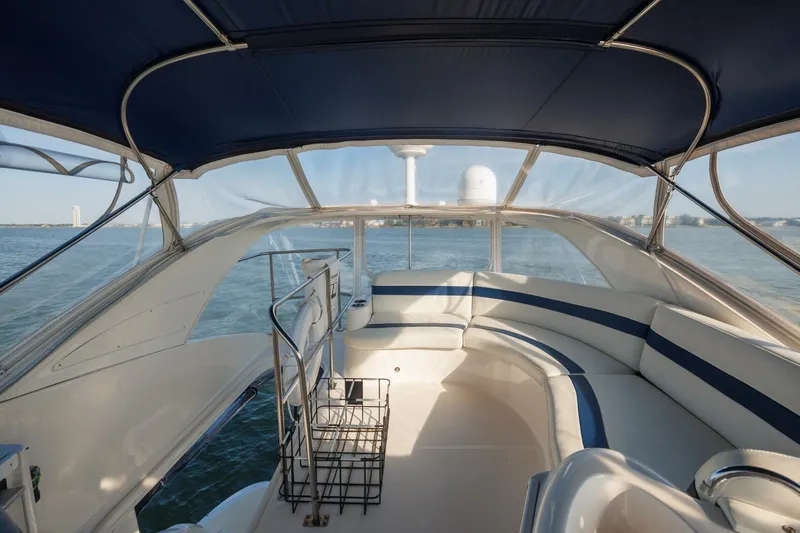 Why Knot Yacht Photos Pics 2010 Meridian 391 Sedan yacht interior with blue canopy and waterfront view.