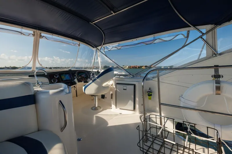 Why Knot Yacht Photos Pics Interior view of 2010 Meridian 391 Sedan yacht with helm and seating area.