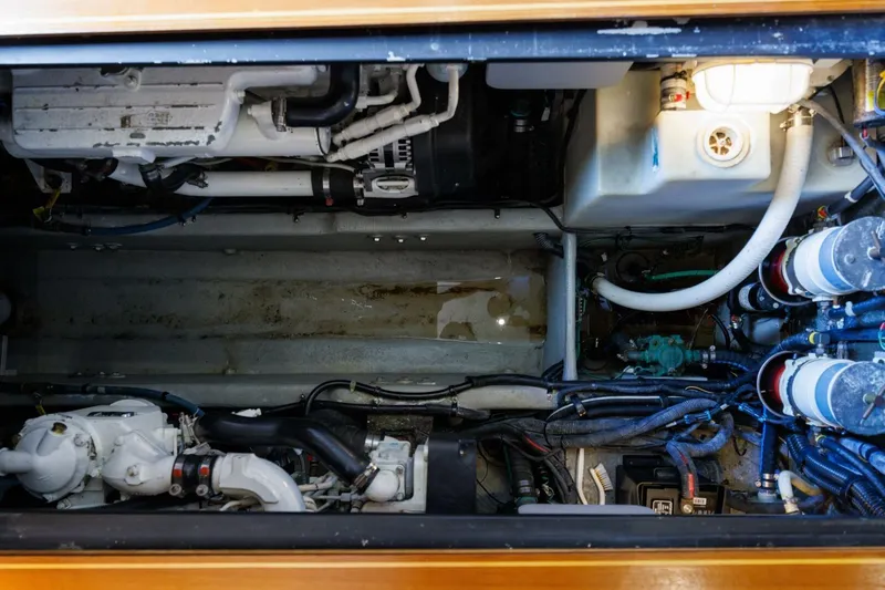 Why Knot Yacht Photos Pics Engine compartment of a 2010 Meridian 391 Sedan boat, showcasing mechanical components.