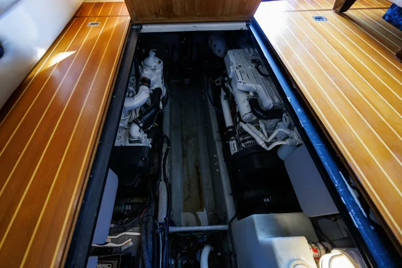 Why Knot Yacht Photos Pics Engine compartment of a 2010 Meridian 391 Sedan yacht with wooden flooring.