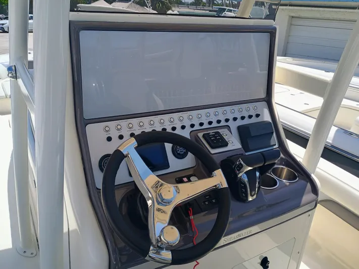 270-912 Yacht Photos Pics 2024 ShearWater 270 Carolina SS Open Bow boat dashboard with steering wheel and controls.