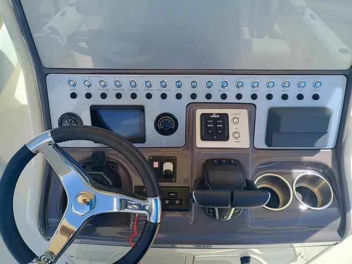 270-912 Yacht Photos Pics 2024 ShearWater 270 Carolina SS Open Bow dashboard with steering wheel and controls.