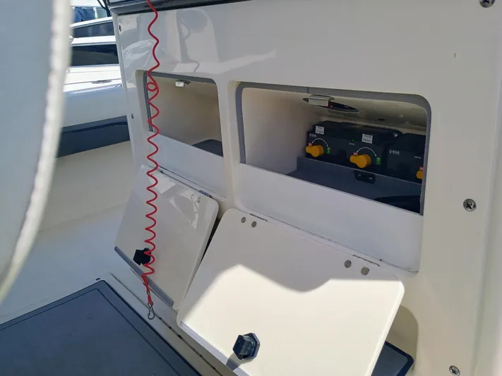 270-912 Yacht Photos Pics 2024 ShearWater 270 Carolina SS Open Bow boat interior with control panel and storage compartments.