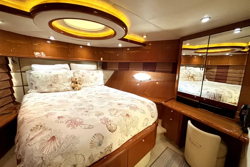  Yacht Photos Pics Luxurious bedroom interior of 2005 Sunseeker 75 Sport Yacht with elegant wood finishes.