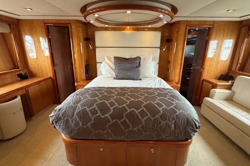  Yacht Photos Pics Luxurious bedroom interior of 2005 Sunseeker 75 Sport Yacht with elegant wood finishes.