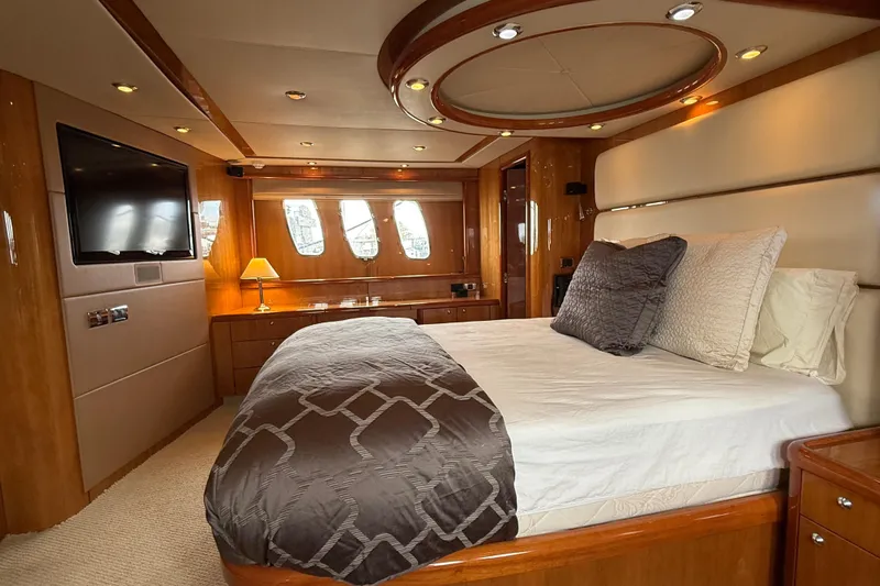  Yacht Photos Pics Luxurious bedroom interior of 2005 Sunseeker 75 Sport Yacht with elegant wood finishes.