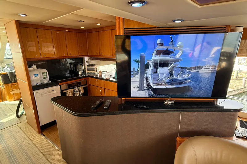  Yacht Photos Pics Luxurious interior of 2005 Sunseeker 75 Sport Yacht with modern kitchen and large TV display.