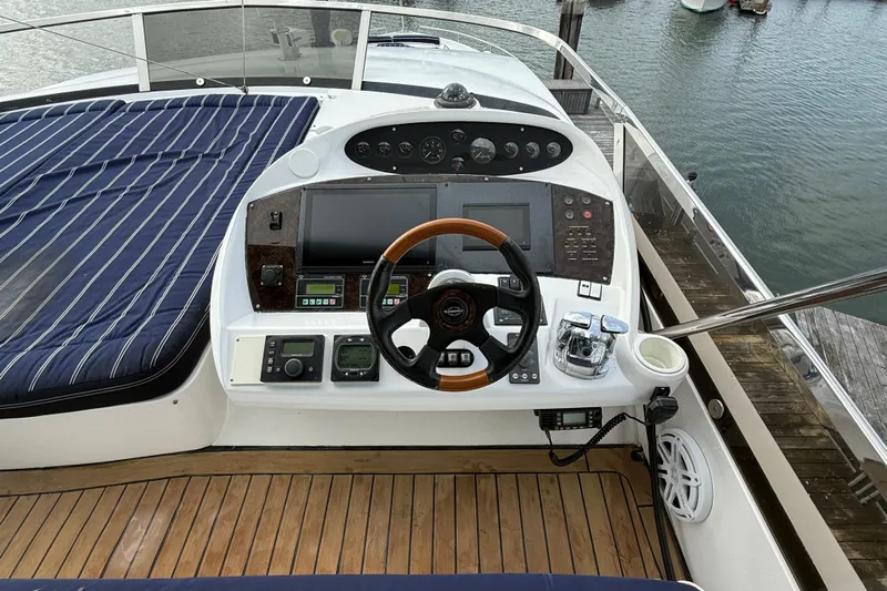  Yacht Photos Pics Cockpit of 2005 Sunseeker 75 Sport Yacht with wooden steering wheel and navigation controls.