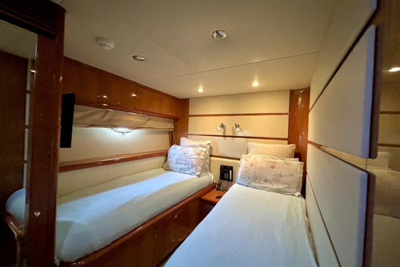  Yacht Photos Pics Luxurious twin cabin in 2005 Sunseeker 75 Sport Yacht, featuring elegant wood finishes.