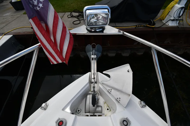  Yacht Photos Pics 2014 Rinker 310 Express Cruiser bow with American flag and anchor.