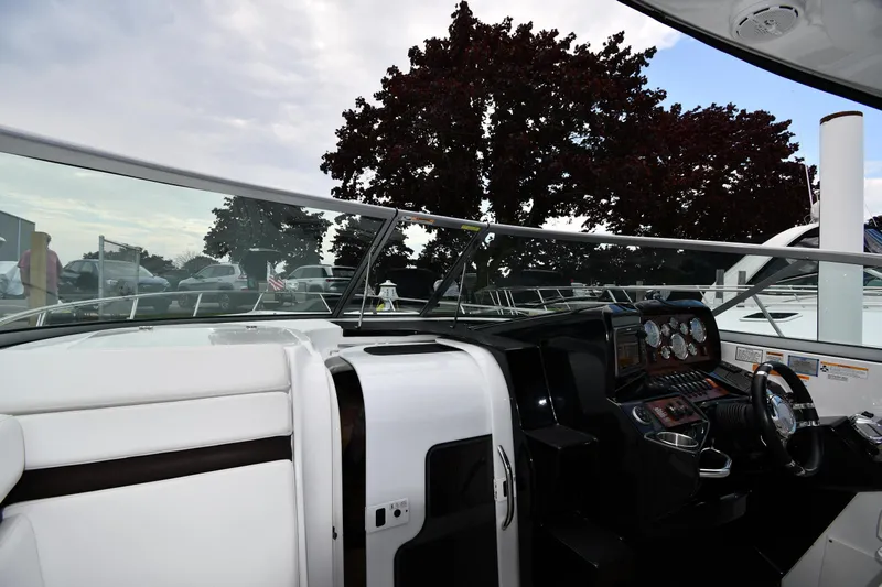  Yacht Photos Pics 2014 Rinker 310 Express Cruiser cockpit with steering wheel and dashboard controls.