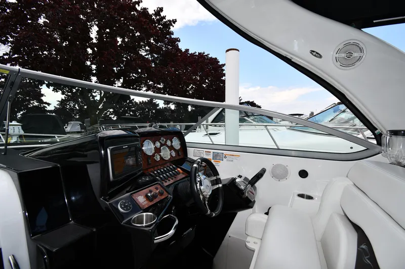  Yacht Photos Pics 2014 Rinker 310 Express Cruiser cockpit with modern controls and comfortable seating.