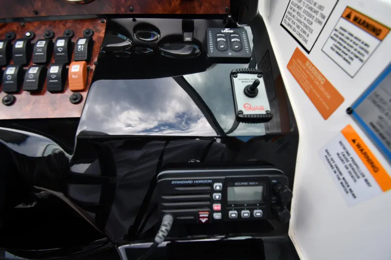  Yacht Photos Pics Control panel of a 2014 Rinker 310 Express Cruiser with switches and radio.
