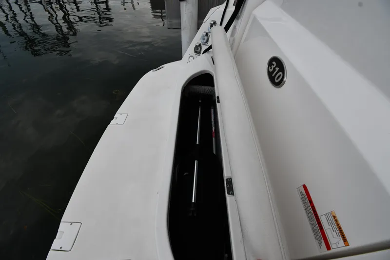  Yacht Photos Pics 2014 Rinker 310 Express Cruiser storage compartment by the water.