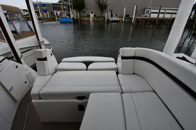  Yacht Photos Pics 2014 Rinker 310 Express Cruiser with white seating, docked at a marina.