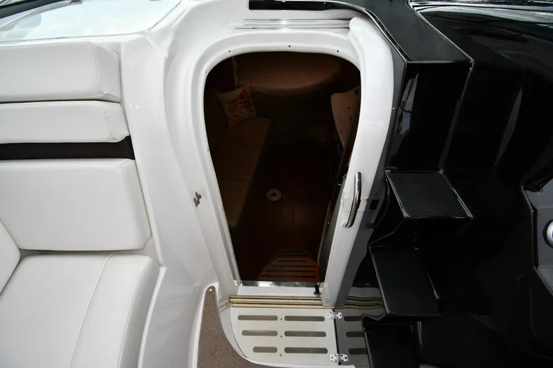  Yacht Photos Pics 2014 Rinker 310 Express Cruiser cabin entrance with white seating and black steps.