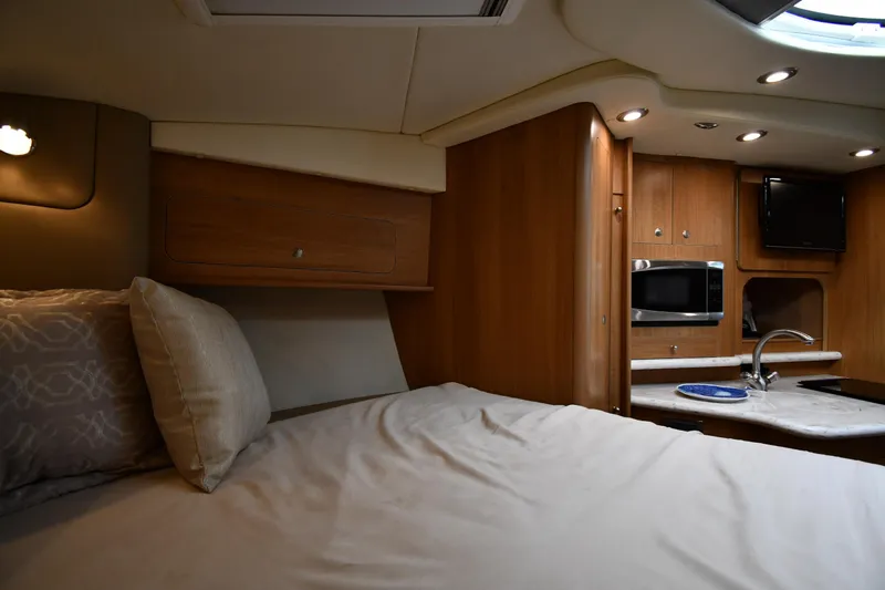 Yacht Photos Pics 2014 Rinker 310 Express Cruiser interior with bed, kitchenette, and modern amenities.