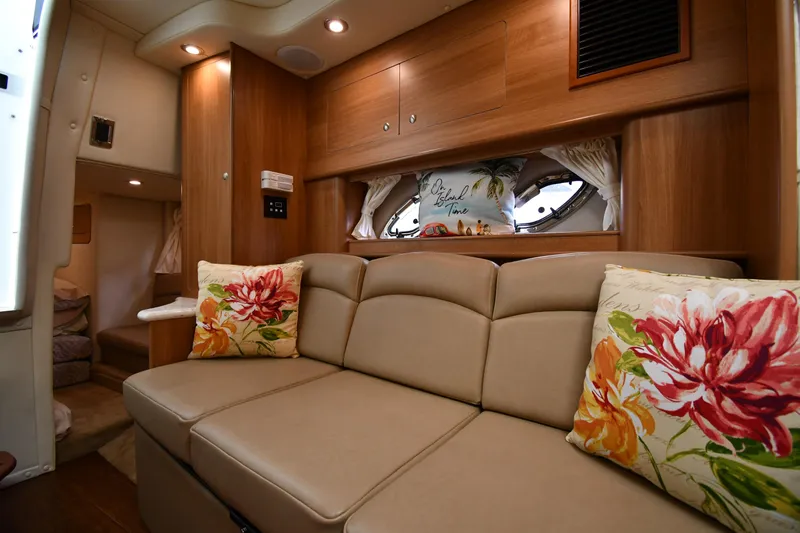  Yacht Photos Pics Interior of 2014 Rinker 310 Express Cruiser with beige sofa and floral pillows.