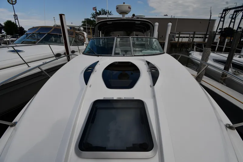  Yacht Photos Pics 2014 Rinker 310 Express Cruiser docked at marina, showcasing sleek design and spacious deck.