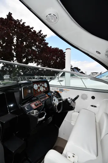  Yacht Photos Pics 2014 Rinker 310 Express Cruiser helm with modern controls and white seating.