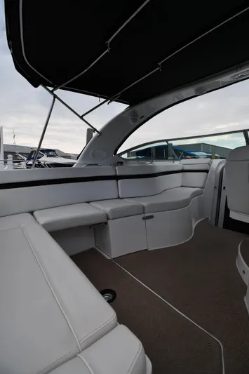  Yacht Photos Pics 2014 Rinker 310 Express Cruiser interior with white seating and canopy.