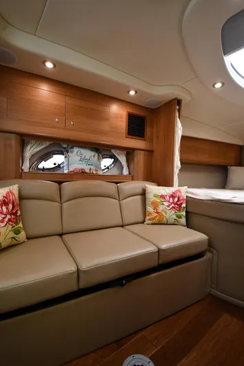  Yacht Photos Pics 2014 Rinker 310 Express Cruiser interior with beige seating and floral cushions.