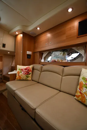  Yacht Photos Pics Interior of 2014 Rinker 310 Express Cruiser with beige seating and floral cushions.