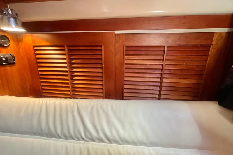  Yacht Photos Pics Interior of 1997 Gozzard 44 yacht with wooden louvered cabinets and cozy seating.