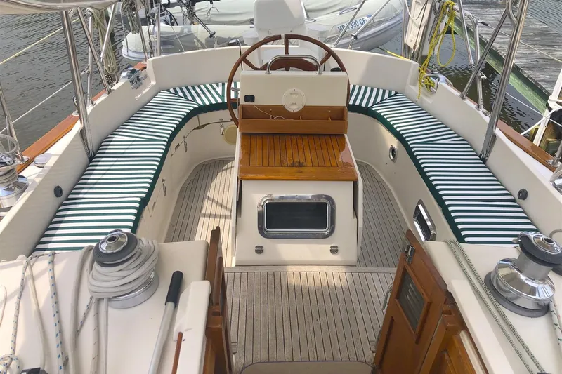  Yacht Photos Pics 1997 Gozzard 44 sailboat cockpit with striped cushions and wooden accents.