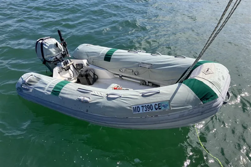  Yacht Photos Pics Inflatable dinghy with outboard motor on water, associated with 1997 Gozzard 44.