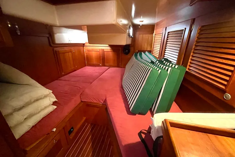  Yacht Photos Pics Cozy cabin interior of 1997 Gozzard 44 sailboat with wooden paneling and cushions.
