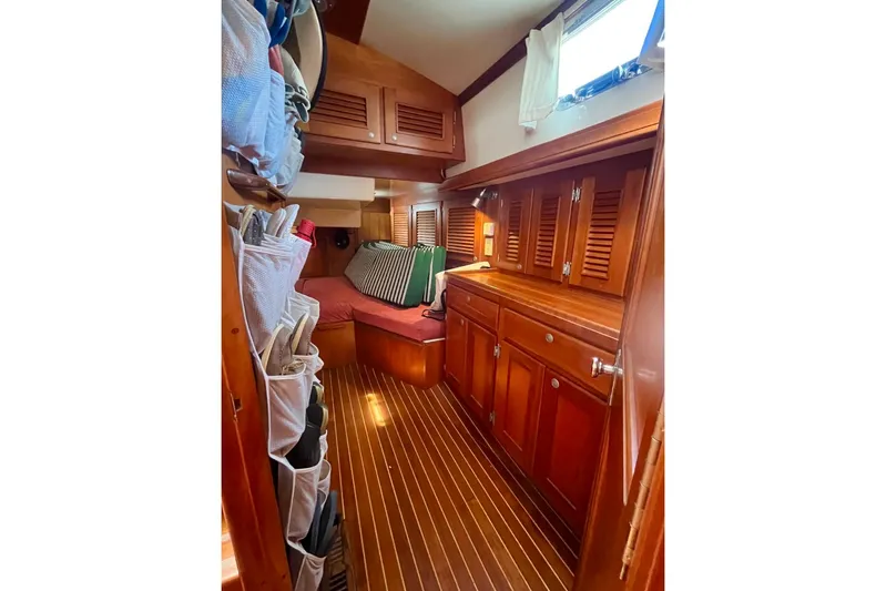  Yacht Photos Pics Cozy 1997 Gozzard 44 yacht interior with wooden cabinetry and striped cushions.