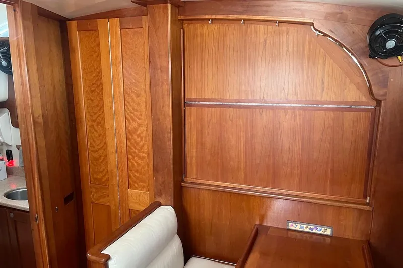  Yacht Photos Pics Interior of 1997 Gozzard 44 sailboat with wooden cabinetry and seating area.