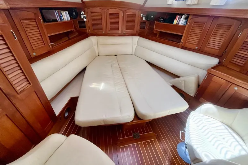  Yacht Photos Pics Luxurious interior of 1997 Gozzard 44 yacht with cream seating and wooden cabinetry.