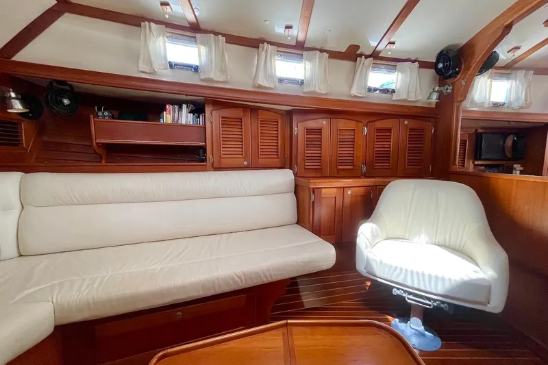  Yacht Photos Pics Interior of 1997 Gozzard 44 yacht with wooden cabinetry and white seating.