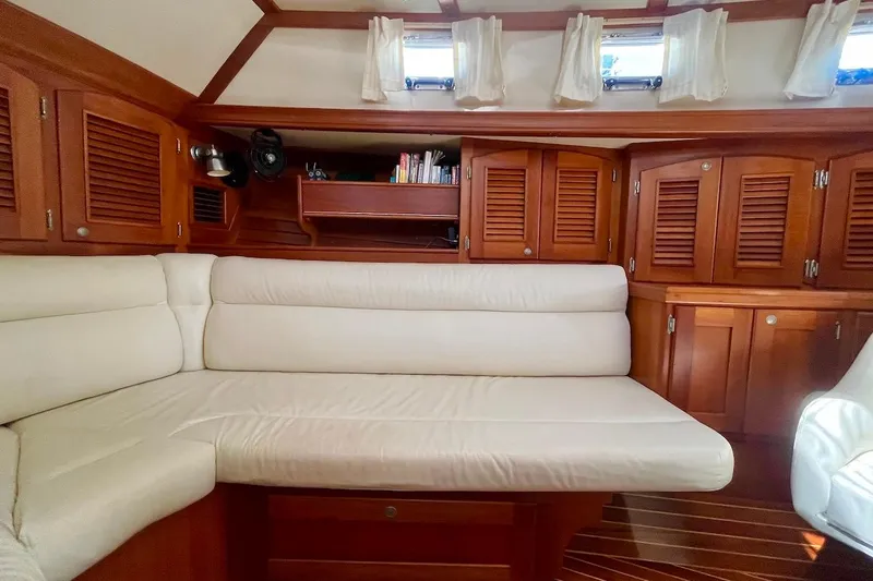  Yacht Photos Pics Interior of 1997 Gozzard 44 yacht with wooden cabinets and white seating.