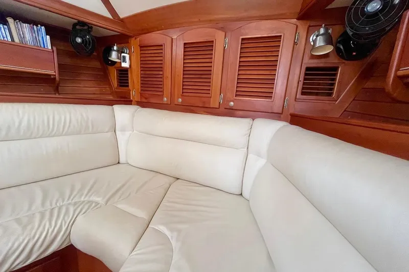  Yacht Photos Pics Luxurious interior of a 1997 Gozzard 44 yacht with plush seating and wooden cabinetry.