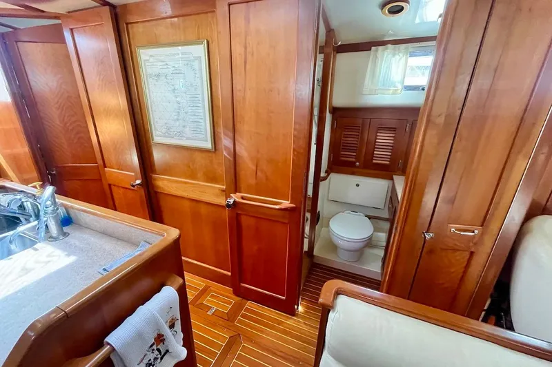  Yacht Photos Pics Interior of 1997 Gozzard 44 yacht featuring wooden cabinetry and compact bathroom.