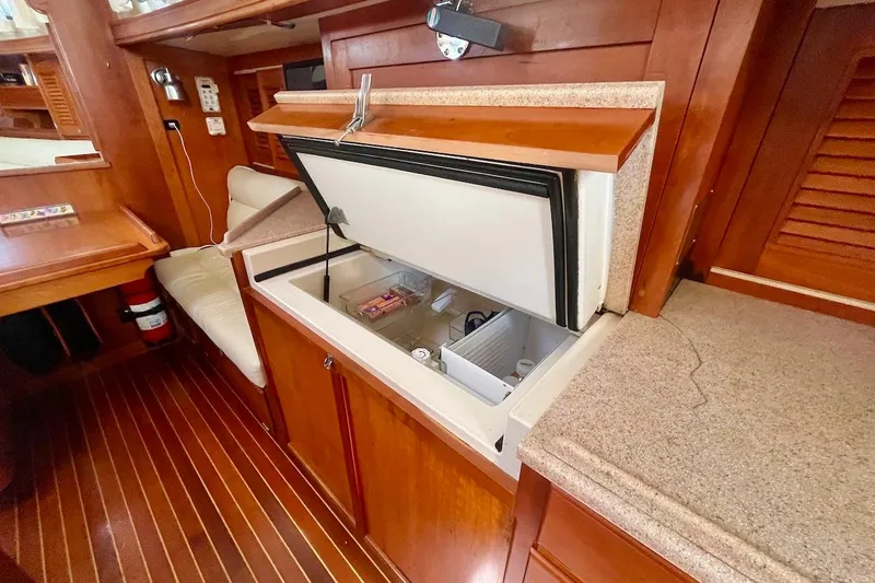  Yacht Photos Pics Interior of 1997 Gozzard 44 yacht showing open refrigerator in wooden galley.