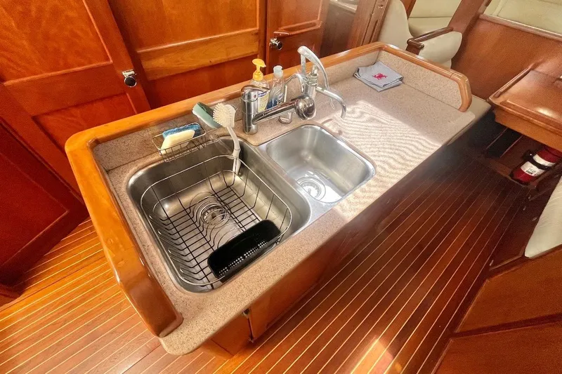  Yacht Photos Pics 1997 Gozzard 44 yacht kitchen with dual sinks and wooden cabinetry.
