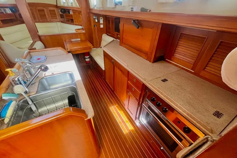  Yacht Photos Pics Luxurious 1997 Gozzard 44 yacht interior with wooden cabinetry and modern kitchen amenities.