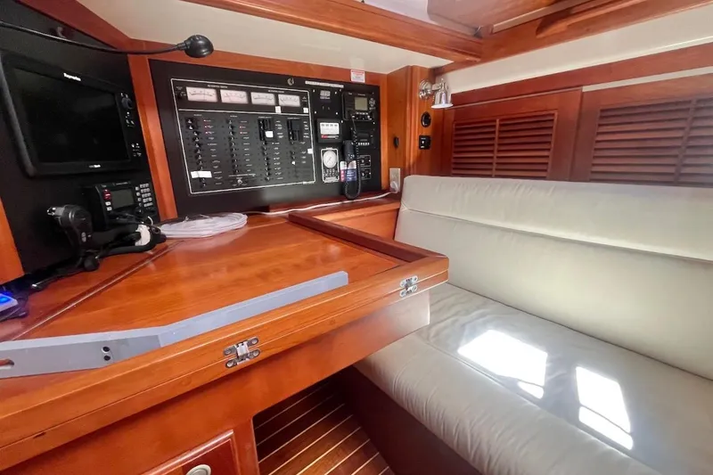  Yacht Photos Pics 1997 Gozzard 44 yacht interior with navigation panel and cushioned seating.