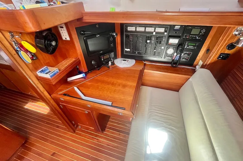  Yacht Photos Pics Navigation station of 1997 Gozzard 44 sailboat with control panel and seating.