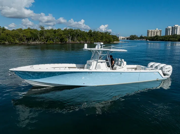  Yacht Photos Pics 2008 SeaVee 39b boat on calm water, clear sky, and distant buildings.