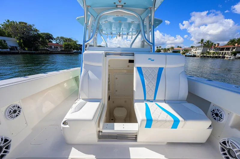  Yacht Photos Pics 2008 SeaVee 39b boat interior with seating and cabin, docked by waterfront homes.